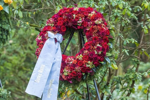 Funeral wreath with flowers at a grave
