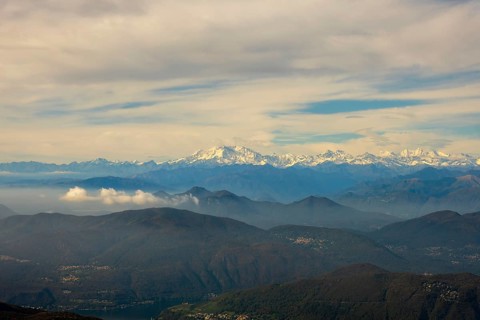 Aerial View over a Beautiful Mountainscape and And Snow Capped Monte Rosa and Mountain Peak Matterhorn and with Floating Clouds in a Sunny Day in Ticino