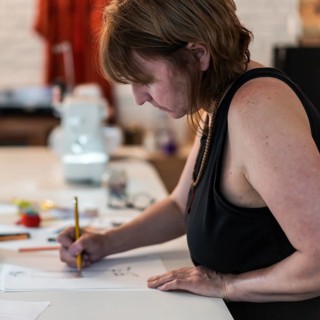 A fashion designer drawing a fashion sketch