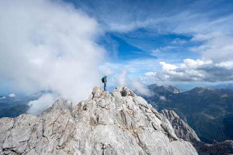 Mountaineer on a narrow rocky ridge