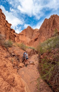 Climber in a canyon with a dry stream bed
