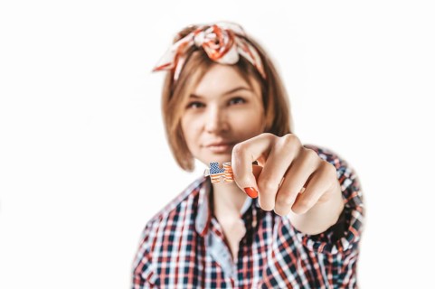Portrait of a girl holding a puzzle with the USA flag. Concept of emigration
