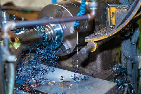 The CNC milling machine cuts metal parts with a milling machine and releasing metal chips. Numerical control workshop