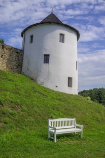 Tower of the fortified village and white bench