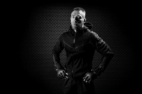 Mixed Martial Arts fighter posing on a metal grid background. Concept of mma