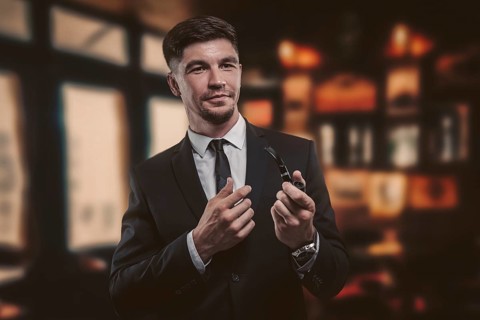 Portrait of an elegant man in a suit with a smoking pipe. Business concept.
