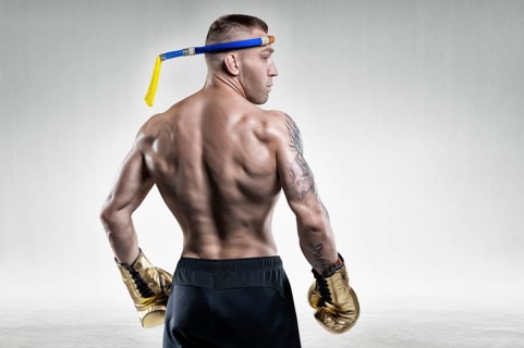 Portrait of a Thai boxer. Back view. Mixed martial arts concept. Competitions and tournaments