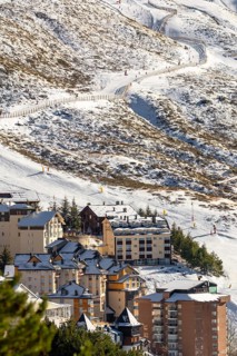 Aerial view of ski resort hotels and slopes with skiers