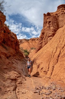 Climber in a canyon with a dry stream bed