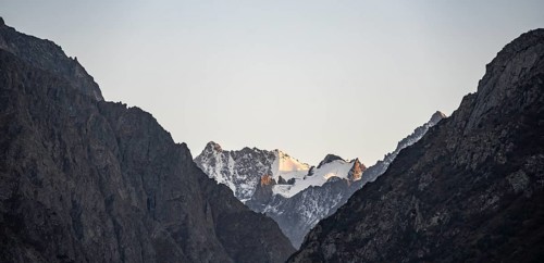 Glaciated mountain peak at sunset