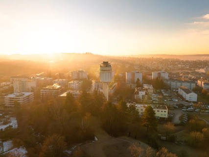 Water tower overlooking the cityscape during a peaceful sunrise