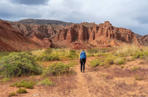 Climber in a canyon with a dry stream bed