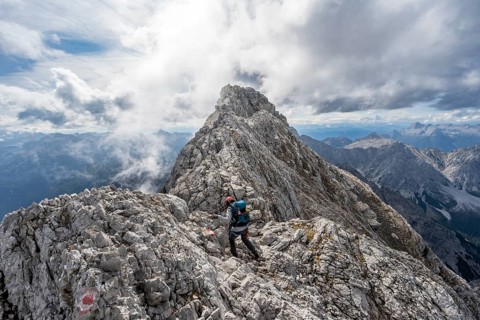 Mountaineer on a narrow rocky ridge