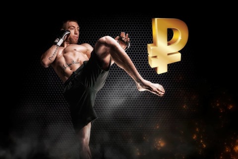 Professional fighter kicks on the icon of the Russian ruble. The concept of crisis