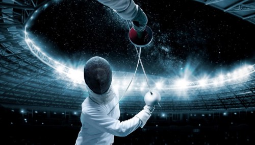 Portrait of two fencers against the backdrop of a sports arena. The concept of fencing. Duel.