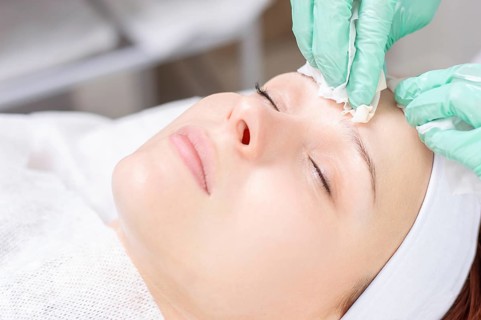 Beautiful girl gets face peeling. Skin health concept. Beauty salons.