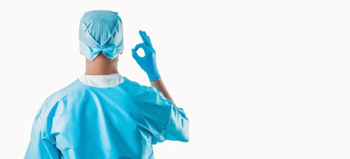 Portrait of a doctor on a white background. He shows an ok sign. The view from the back. Medicine concept.