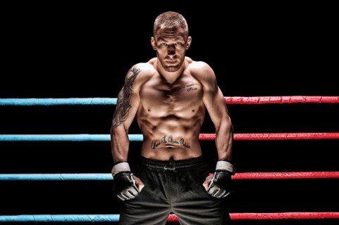Mixed martial artist posing in boxing ring. Concept of mma