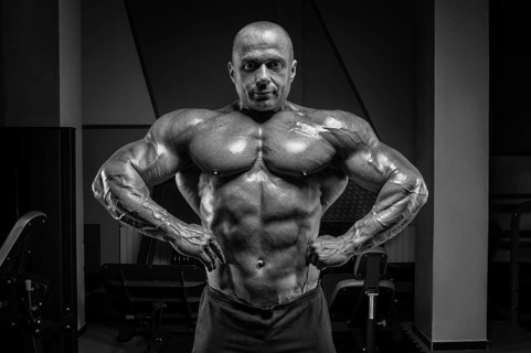 Professional weightlifter posing in the gym. Classic bodybuilding.