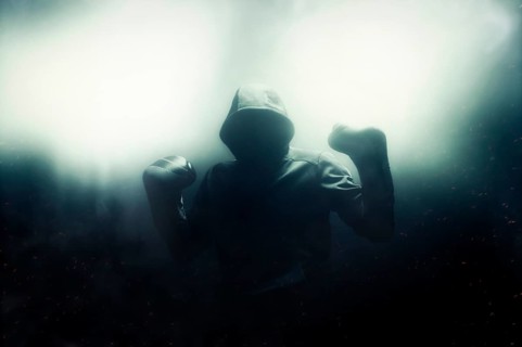 Fighter without a face is standing with his hands up. The concept of boxing