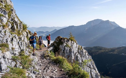Three mountaineers on a hiking trail