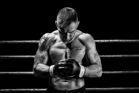 Mixed martial artist posing on a black background. Concept of mma