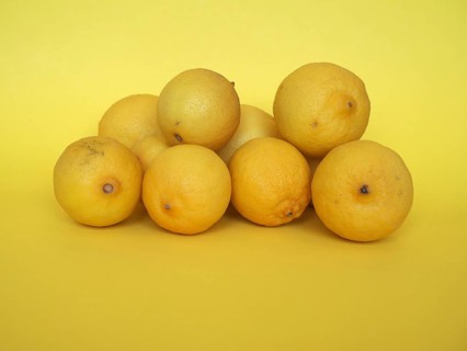 Lemon fruits over yellow background
