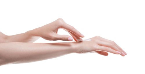 Image of female hands applying cream to the skin. Medical concept of healthy skin and hand care.