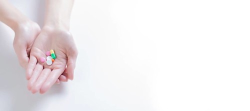 Image of pills on a female palm. The concept of medicine