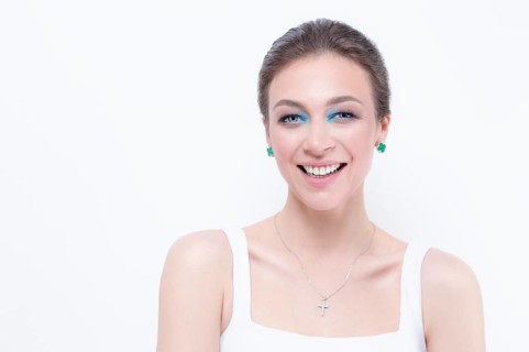 Portrait of a beautiful girl with a defiant make-up. White background. Beauty concept. High quality
