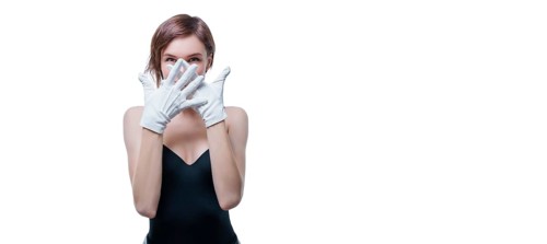 Confused girl in white gloves posing in the studio on a white background. No name portrait