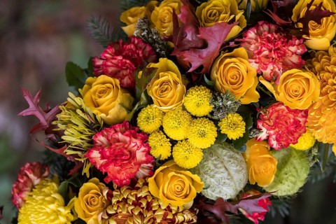 Funeral wreath with flowers at a grave