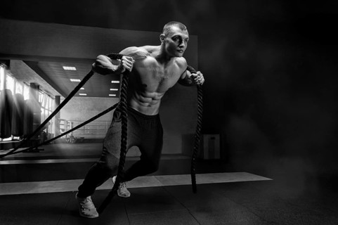Portrait of an athlete who pulls the ropes. View from below. The concept of sport and healthy lifestyle.