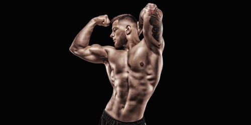 Young muscular guy posing in the studio. Fitness and nutrition concept.