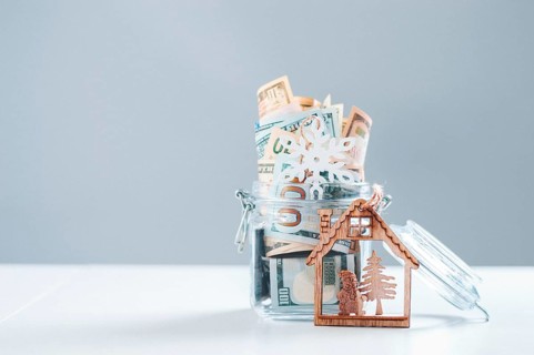 Glass piggy bank full of money. Christmas and New Year concept. Gift expenses.