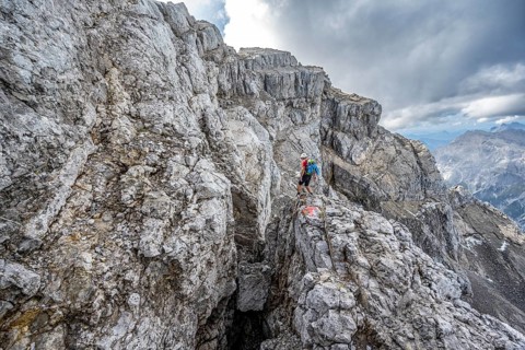 Mountaineer on a narrow rocky mountain path