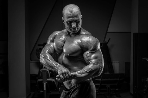 Professional weightlifter posing in the gym. Classic bodybuilding.