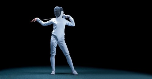 Charming girl dressed as a fencer posing with a mask and a sword. The concept of fencing.