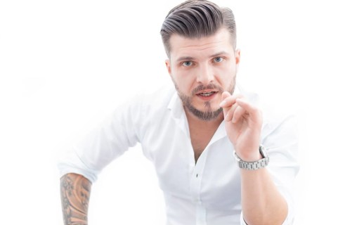 Confident man in a shirt looks at the camera and instructs a potential employee. The concept of mentoring