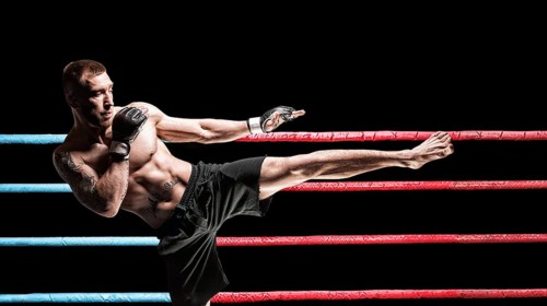 Kickboxer posing in the ring. Middle Kick. The concept of mma
