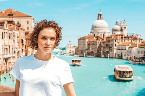 Portrait of a charming girl with a view of santa maria della salute. Travel and vacation concept.