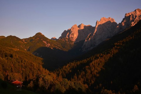 The last rays of sunlight illuminate the peaks of the Wilder Kaiser