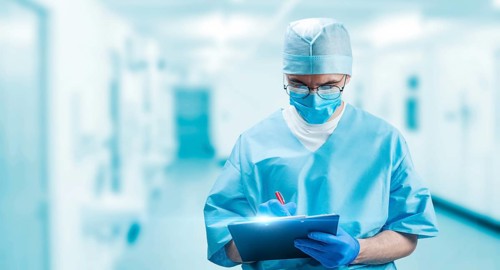 Portrait of a doctor who fills out an insurance policy. Medicine concept.