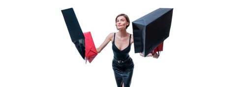 Cheerful positive girl jumps up with happiness and waving shopping bags. The concept of holiday gifts