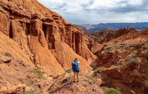 Climber in a canyon with a dry stream bed