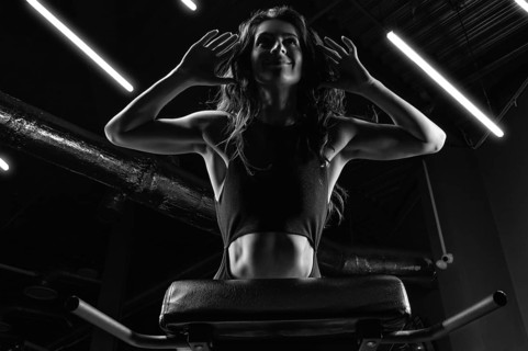 Charming brunette doing hyperextension in the gym. Press pumping. Fitness and bodybuilding concept.