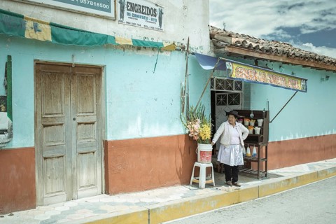 Woman in front of her devotional shop