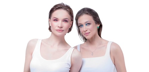 Portrait of two beautiful girls with defiant make-up on a white background. Female friendship concept. High quality