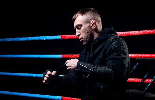 Mixed martial artist wraps bandages around his fist. Concept of mma