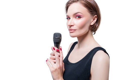 Portrait of an elegant stylish woman with a microphone. White background. Karaoke concept.